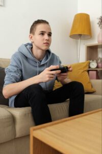 Young person playing video games on the couch